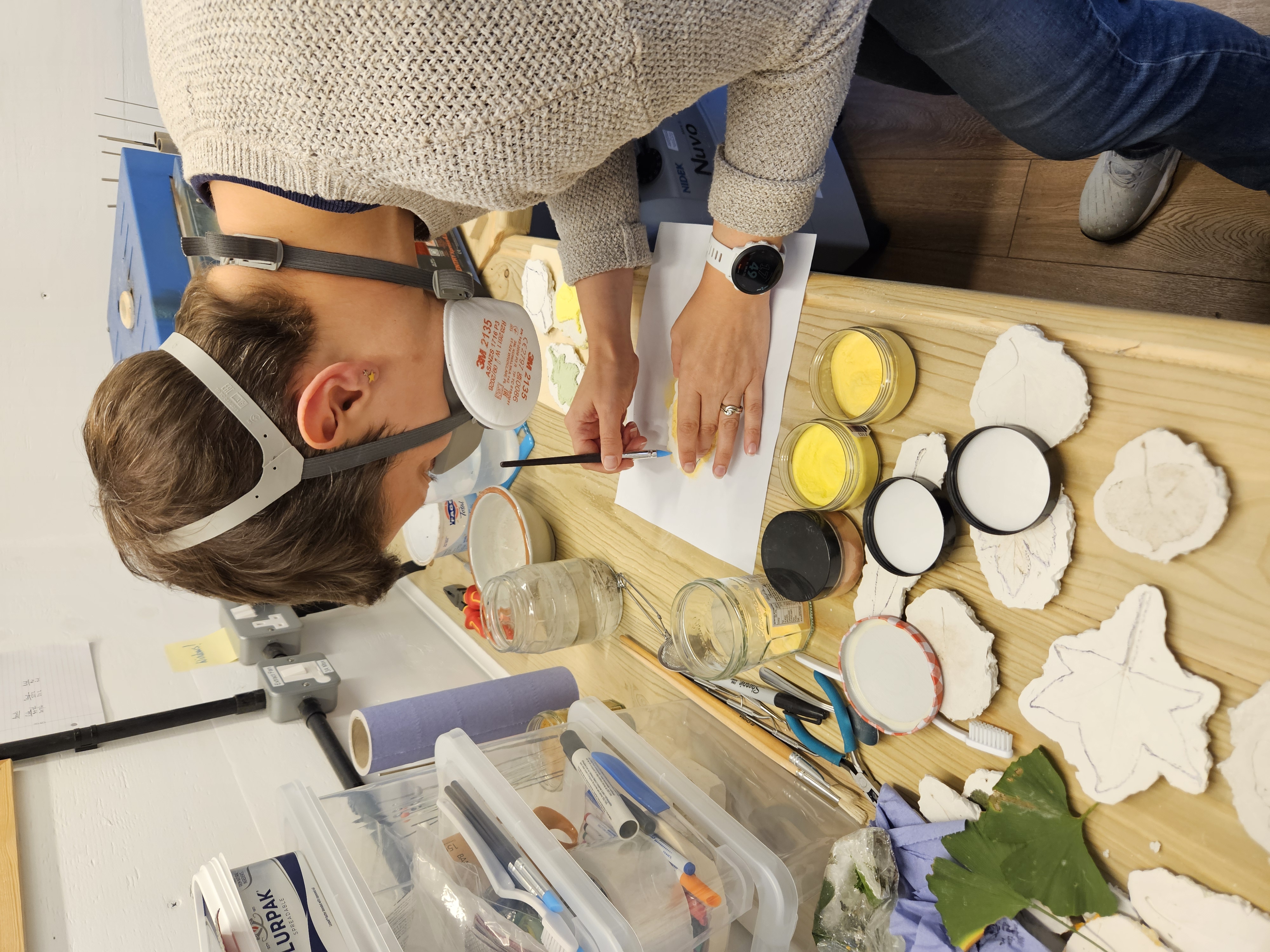 Penny working in her studio making glass leaves with glass powder